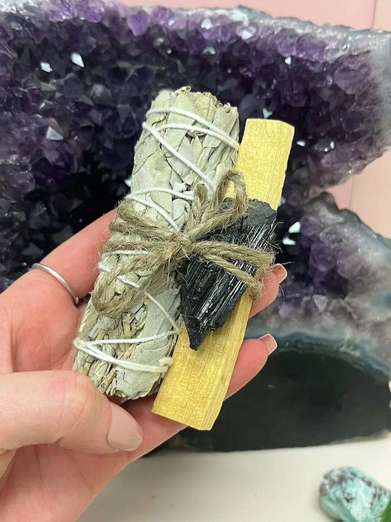 Cleansing raw black tourmaline shielding stones under full moonlight on a selenite charging plate